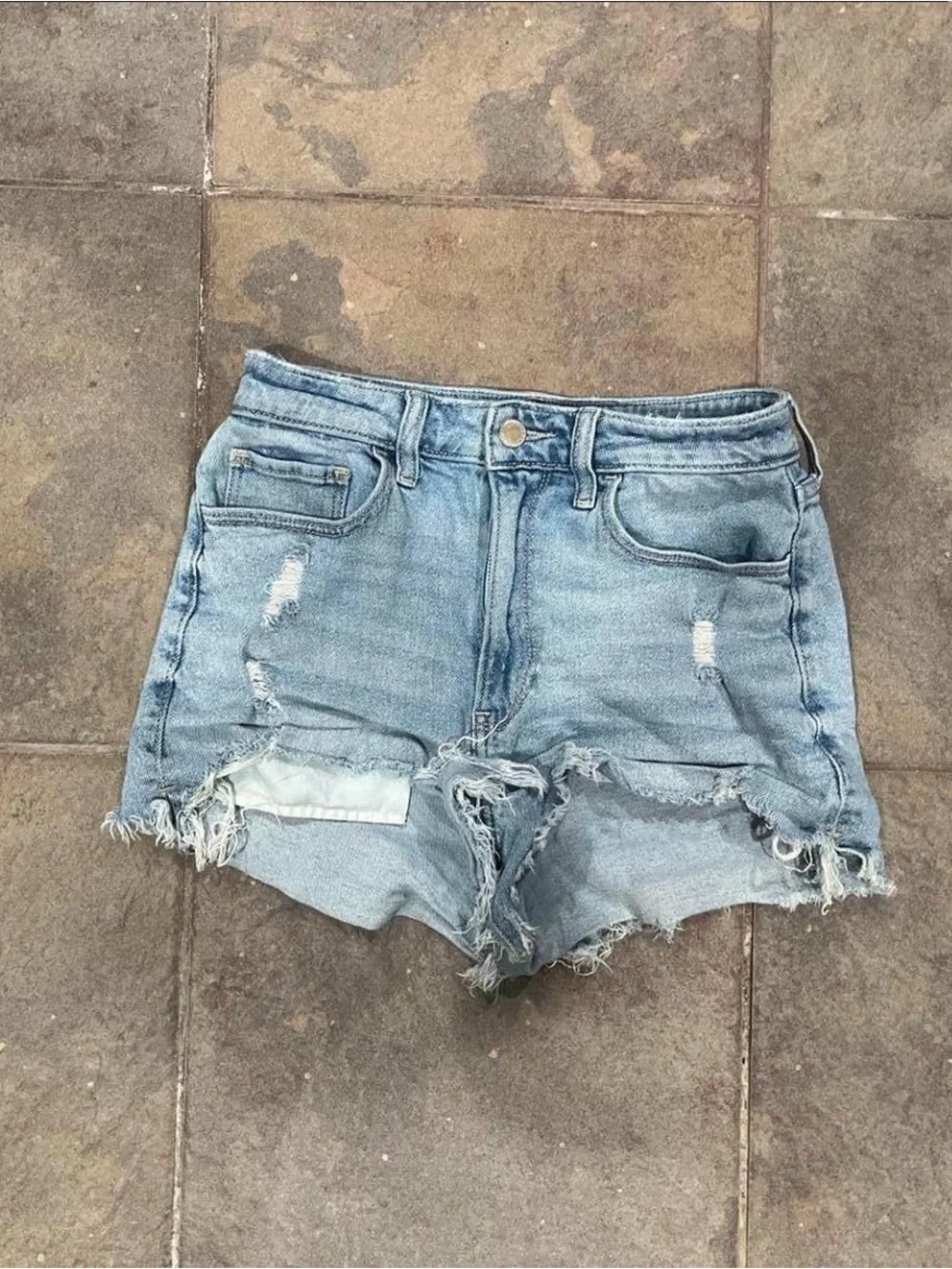 Light blue denim shorts with frayed hem